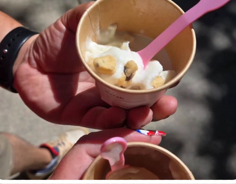 Two guests holding cups of Swirld soft serve at an event